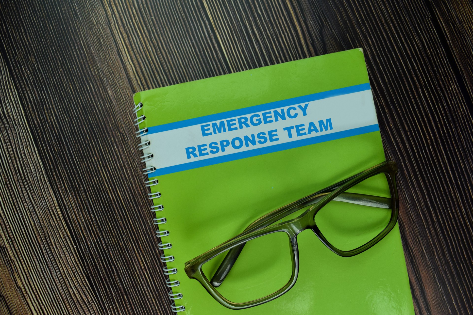 The Book of Emergency Response Team isolated on wooden table